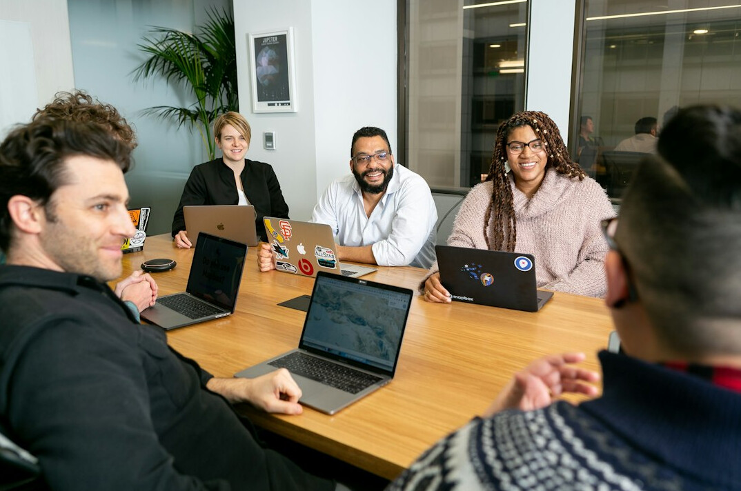 team discussing insurance tech